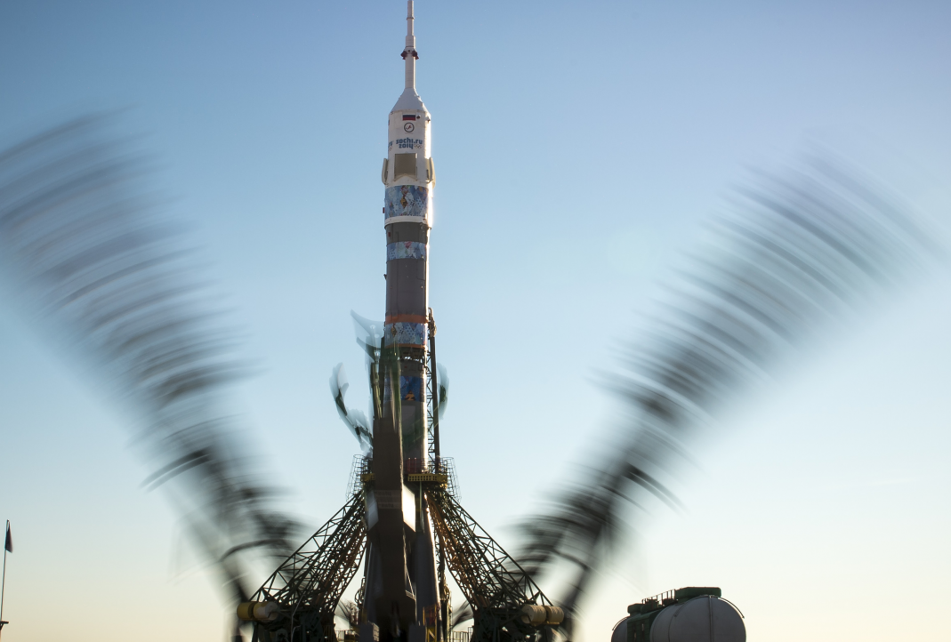 Olympic torch back on Earth after landmark spacewalk